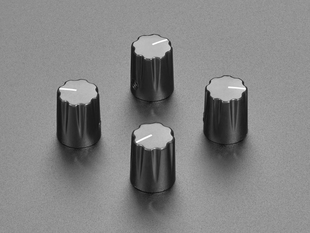 Angled shot of four black micro knobs.