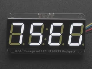 White 7-segment clock display soldered to backpack with all segments lit