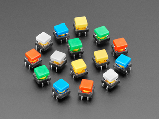 Angled  shot of 15 colorful square tactile button switches in green, yellow, red, blue, and white.