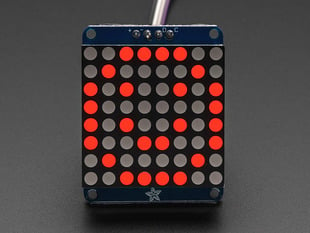Adafruit Small 1.2" 8x8 Red LED Matrix w/I2C Backpack assembled and powered on. A red graphic smiley is displayed.