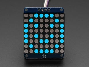 Adafruit Small 1.2" 8x8 Blue LED Matrix w/I2C Backpack assembled and powered on. A blue graphic smiley is displayed.
