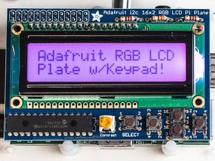 Top down view of a Adafruit RGB Positive 16x2 LCD+Keypad Kit for Raspberry Pi with Purple background. 