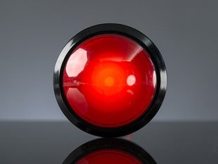 Head-on shot of illuminated massive red 100mm arcade button.