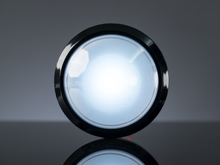 Head-on shot of illuminated massive white 100mm arcade button.