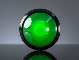 Head-on shot of massive 100mm green arcade button.