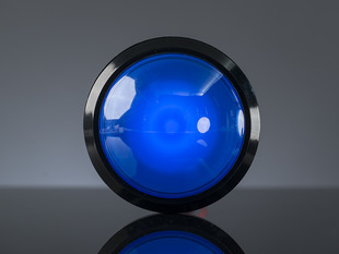 Head-on shot of illuminated massive blue 100mm arcade button.