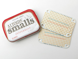 Top view of a small Altoids breath mint case with two Adafruit Perma-Proto Small Mint Tin Size Breadboard PCBs.
