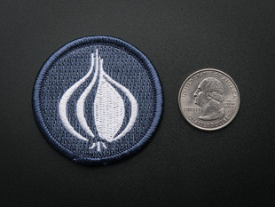 Circular embroidered badge of stylized onion Perl logo in white, on a greyish blue background. 