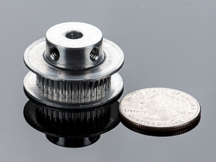 Aluminum Timing Pulley next to quarter