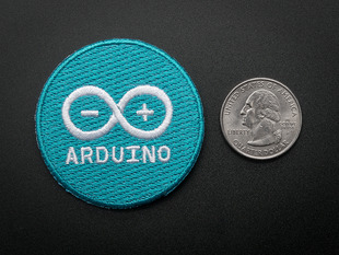 Circular embroidered badge in turquoise with the word ARDUINO and their infinity logo + - in white. 