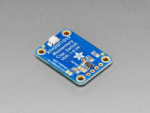 Angled shot of blue, rectangular capacitive touch sensor breakout board.