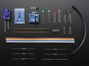 Collection of loose components in kit: PCBs, XBees, connectors, ribbon cable, and other parts.