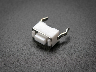 angled shot of single white 6mm tactile switch button.