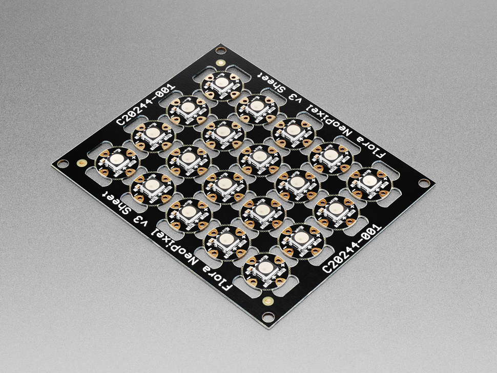 Angled shot of PCB sheet of 20 break-off LEDs.