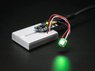 Glowing NeoPixel Mini Button PCB wired up to a microcontroller