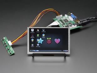Angled shot of an assembled HDMI 4 Pi 5" Display not Touchscreen 800x480. The HDMI screen displays a desktop image including the Adafruit logo, the Raspberry Pi logo, and a pink heart.