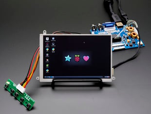 Angled shot of an assembled 5.6" Display & Audio Kit. The HDMI screen displays a desktop image including the Adafruit logo, the Raspberry Pi logo, and a pink heart. 