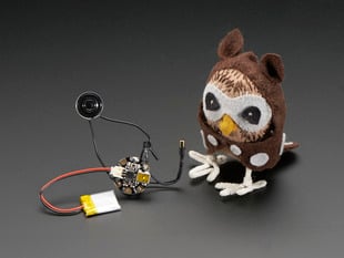Assembled electronic parts included in kit next to a plush Owl. 