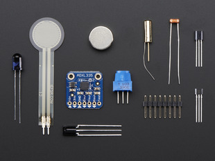 Kit components showing various sensors, LED, magnet and some header