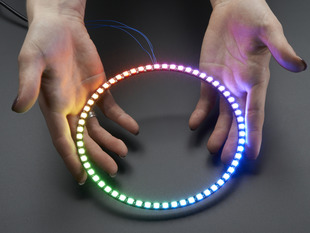 Hand holding NeoPixel Ring with 60   x 5050 RGB LED, lit up rainbow