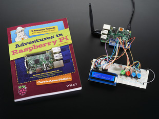 Adventures in Raspberry Pi book next to assembled project with Raspberry pi and LCD plus buttons