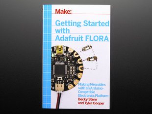Front cover of Make: Getting Started with Adafruit FLORA. Making wearables with an Arduino-compatible electronics platform. By Becky Stern and Tyler Cooper. Topdown shot of a round dev board wired to LED PCBs.
