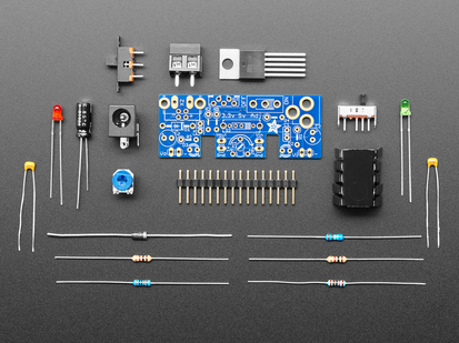 Unassembled kit shot with PCB, various components, chips, resistors, etc.