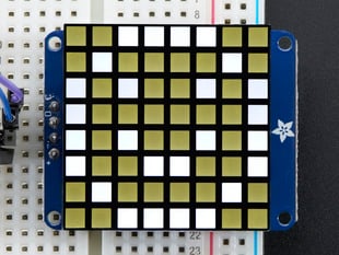 Close-up of soldered and assembled Small 1.2" 8x8 Ultra Bright Square White LED Matrix + Backpack on a breadboard powered by an Arduino Uno. The LED Matrix displays a white smiley.