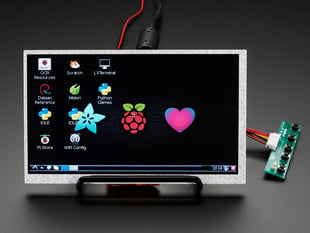 Angled shot of a HDMI 4 Pi: 7" Display (no Touch) w/Mini Driver. The monitor displays a desktop background with a adafruit logo, raspberry logo, and a heart. 