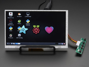 Angled shot of a HDMI 4 Pi: 7" Display no Touchscreen. The monitor displays a desktop background with a adafruit logo, raspberry logo, and a heart. 