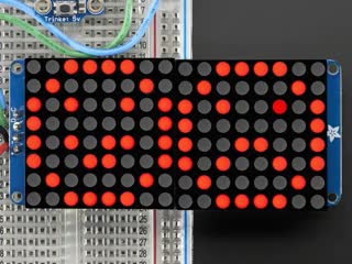Animation of close-up of soldered and assembled 16x8 1.2" LED Matrix + Backpack - Ultra Bright Round LEDs on a breadboard. The LED Matrices display a smiling emoji and a frowning emoji in different colors.