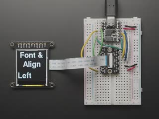 Overhead video of TFT display running boot-up animation including accelerometer and colored polygons.