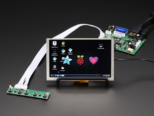 Angled shot of an assembled HDMI 4 Pi: 5" Display. The HDMI screen displays a desktop image including the Adafruit logo, the Raspberry Pi logo, and a pink heart.