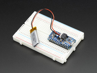 Adafruit LiIon/LiPoly Backpack soldered onto a Pro Trinket, plugged into a solderless breadboard.