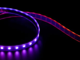 Part of a coiled LED strip glowing purple LEDs.