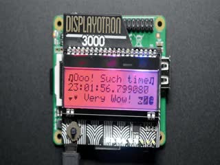 Video of assembled and powered on Pimoroni Display-O-Tron 3000. The LCD displays a rainbow gradient with the text: "Ooo! Such time 23:02 Very Wow!"