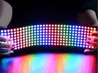 Video of two hands bending a Flexible 8x32 NeoPixel RGB LED Matrix. 