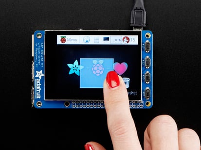 Red polished nail touching the screen of a Adafruit PiTFT Plus 320x240 2.8" TFT + Capacitive Touchscreen. 