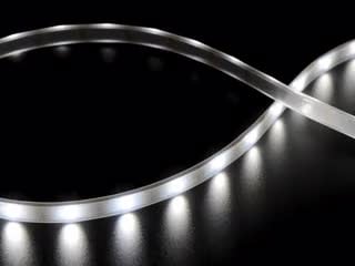 Video of Part of a coiled LED strip fading in and out glowing white LEDs.