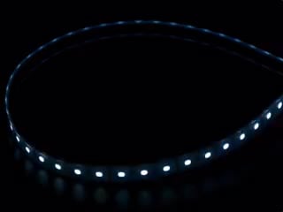 Coiled cool white LED strip with LEDs changing color throughout rainbow and also white