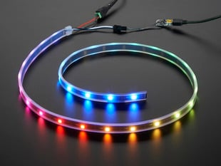 Adafruit NeoPixel Digital RGB LED Strip wired to a microcontroller, with all the LEDs in a rainbow