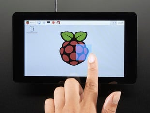 Top down view of a finger touching the screen of a Pi Foundation Display - 7" Touchscreen Display for Raspberry Pi. 