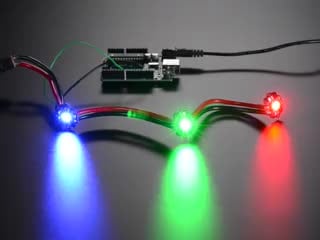Animation of three very bright chained LEDs all changing rainbow colors
