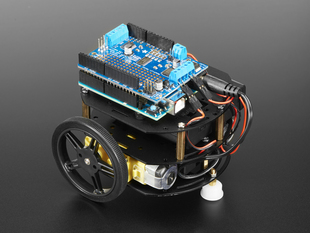 Angled shot of three-layer round robot in black metal with Arduino plus motor shield connected to motors.