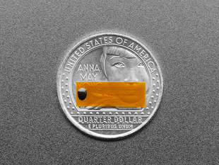 Miniature flexible RFID tag on top of quarter