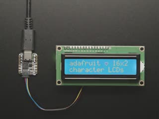 Overhead video demo of an LCD backpack wired to a small square microcontroller. Display on LCD reads: "adafruit (heart symbol) 16x2 character LCDs"