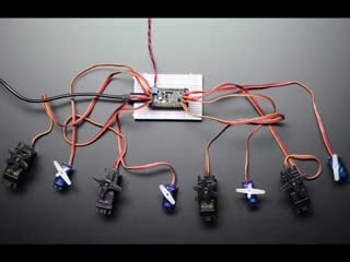 Top down view of several servos powered by 8-Channel PWM or Servo FeatherWing Add-on For All Feather Boards.