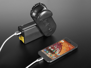 Still image of a Hand-Crank Power Outlet charging a smart phone.
