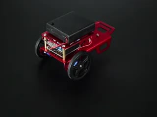 Two-wheeled robot turning around a few times and then driving off.