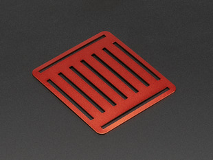 Angled shot of slotted red aluminum sheet.
